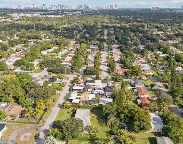 an aerial view of residential houses with city view