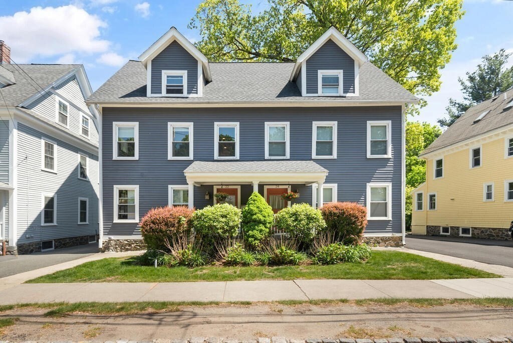 22 Fletcher Street, Unit 22 Winchester, MA 01890 - Photo 1 of 31 a front view of a house with a yard and garage