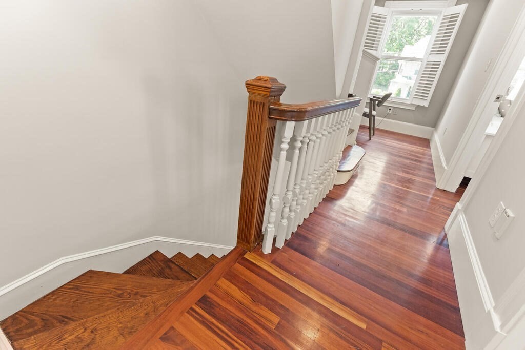 22 Fletcher Street, Unit 22 Winchester, MA 01890 - Photo 13 of 31 a view of a hallway with wooden floor and staircase