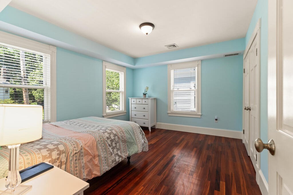 22 Fletcher Street, Unit 22 Winchester, MA 01890 - Photo 15 of 31 a bedroom with a bed and wooden floor