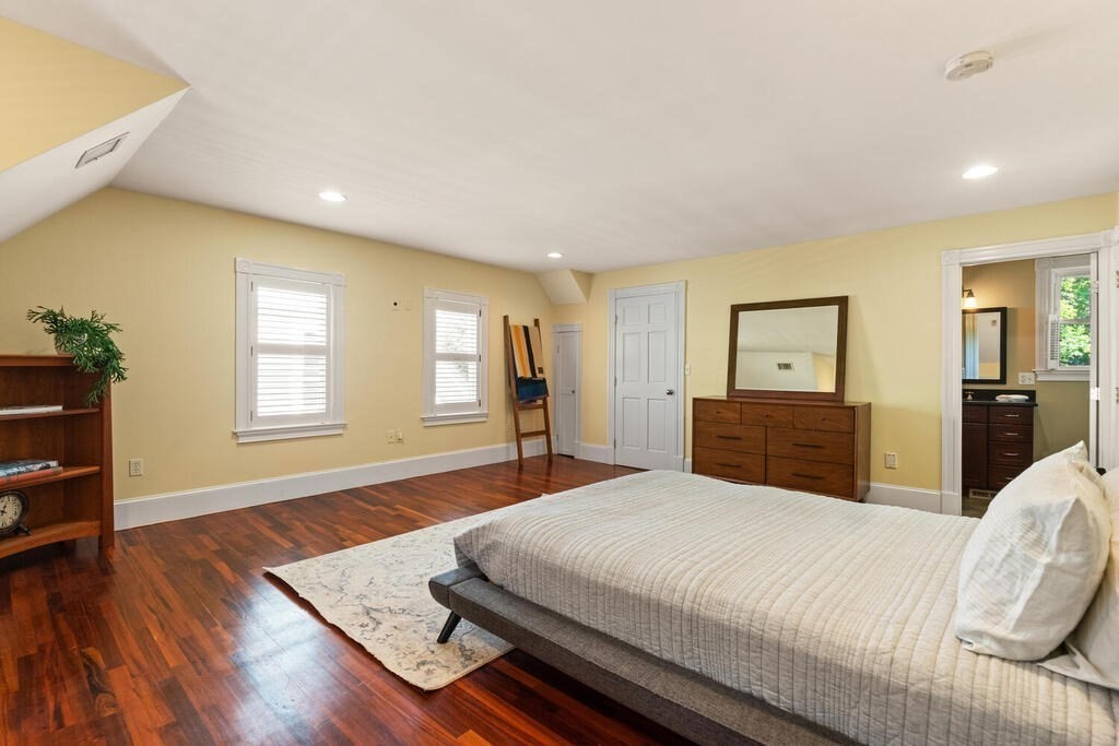 22 Fletcher Street, Unit 22 Winchester, MA 01890 - Photo 18 of 31 a large bedroom with wooden floor and window