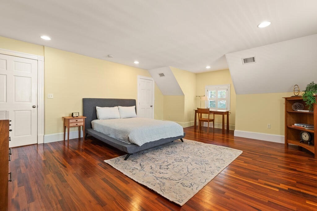 22 Fletcher Street, Unit 22 Winchester, MA 01890 - Photo 19 of 31 a spacious bedroom with a bed and wooden floor