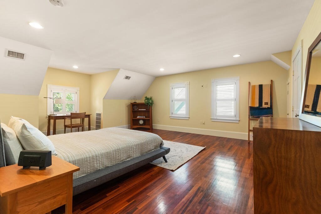 22 Fletcher Street, Unit 22 Winchester, MA 01890 - Photo 20 of 31 a spacious bedroom with a bed and wooden floor