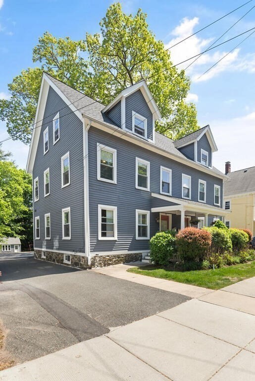 22 Fletcher Street, Unit 22 Winchester, MA 01890 - Photo 2 of 31 a front view of a house with a garden
