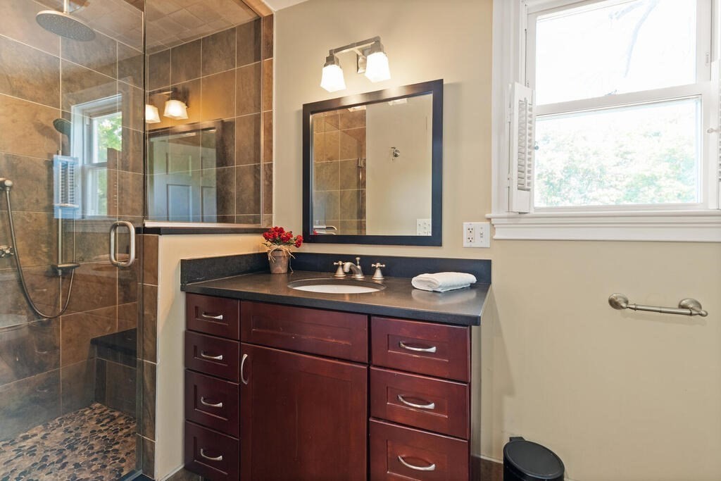 22 Fletcher Street, Unit 22 Winchester, MA 01890 - Photo 21 of 31 a bathroom with a sink and a mirror