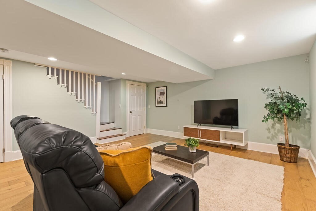 22 Fletcher Street, Unit 22 Winchester, MA 01890 - Photo 22 of 31 a living room with furniture and a flat screen tv