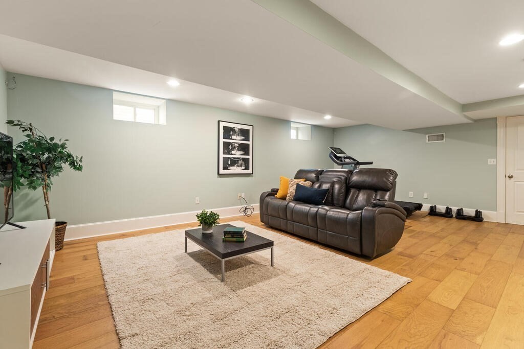 22 Fletcher Street, Unit 22 Winchester, MA 01890 - Photo 23 of 31 a living room with furniture and flowers