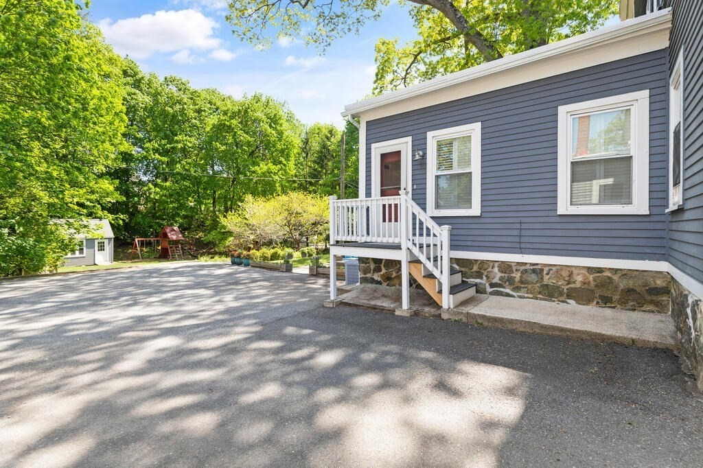 22 Fletcher Street, Unit 22 Winchester, MA 01890 - Photo 27 of 31 a view of a chairs and table in the back yard