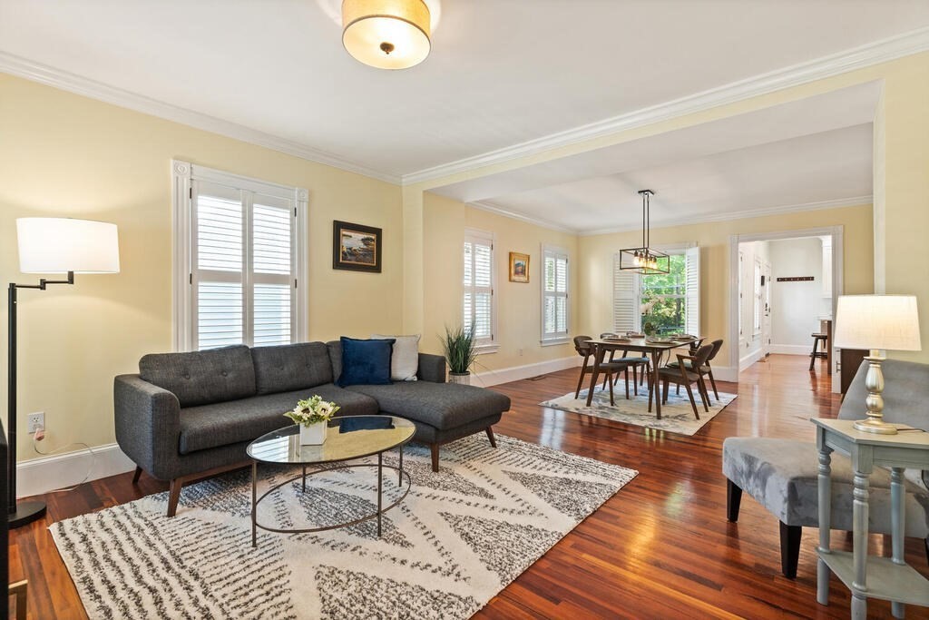 22 Fletcher Street, Unit 22 Winchester, MA 01890 - Photo 5 of 31 a living room with furniture and wooden floor