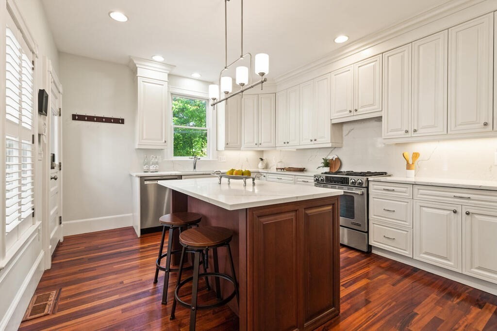 22 Fletcher Street, Unit 22 Winchester, MA 01890 - Photo 10 of 31 a kitchen with stainless steel appliances granite countertop a sink a stove and a refrigerator
