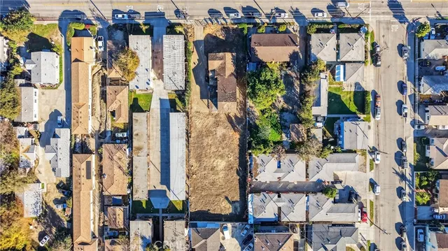 an aerial view of a houses with yard