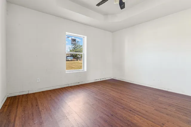 a view of a room with wooden floor