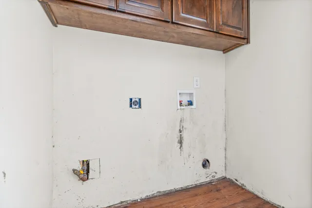 a view of a room with wooden floor and a window