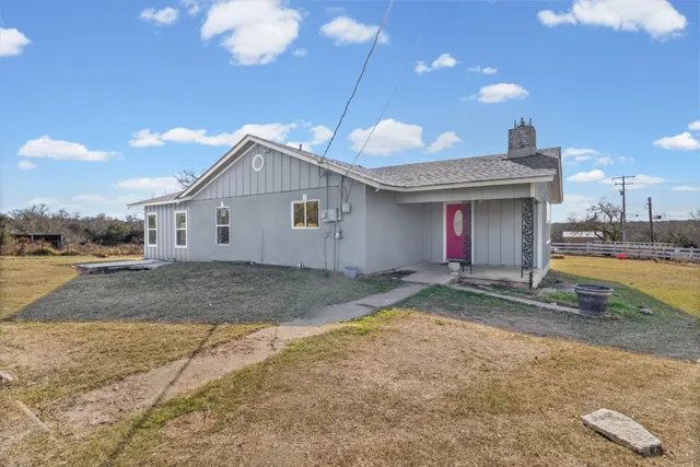 a view of a house with a yard and garage
