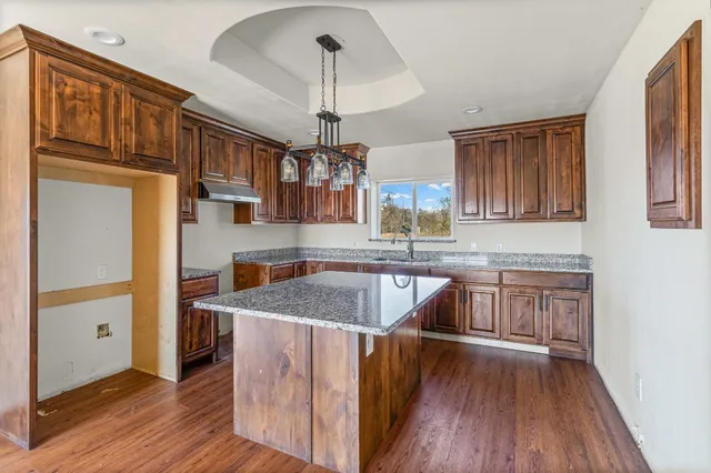 a kitchen with stainless steel appliances granite countertop a sink stove and cabinets