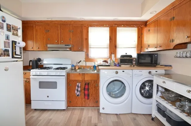 a utility room with sink dryer and washer