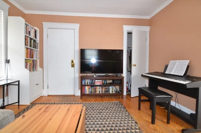 a bedroom with furniture and a flat screen tv