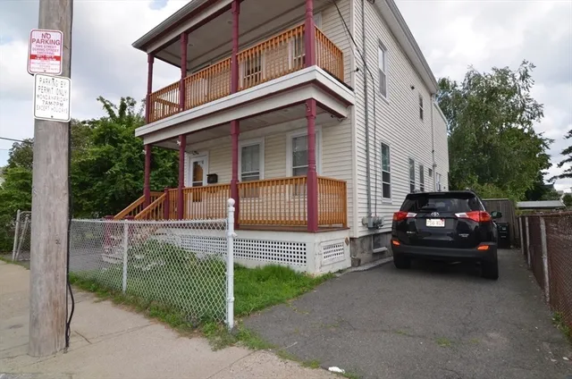 a view of a car park in front of house
