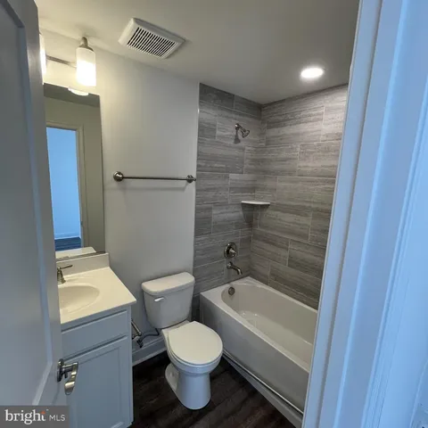 a bathroom with a toilet a sink and bathtub