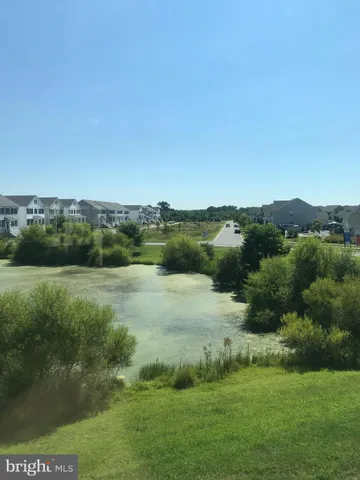 a view of a green field with clear sky
