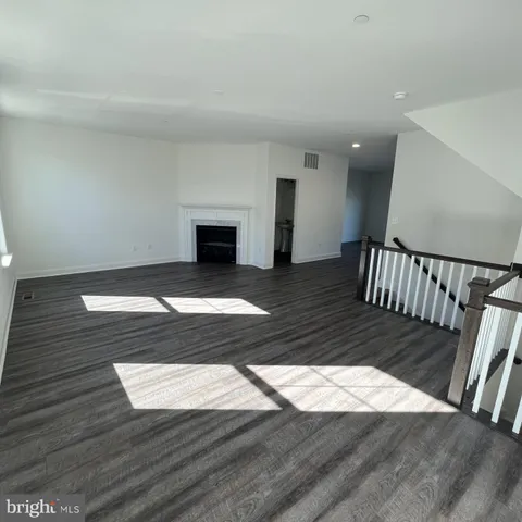 a view of entryway wooden floor and front door