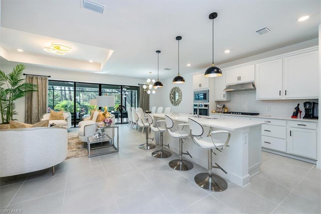 10499 Ventana Lane Naples, FL 34120 - Photo 4 of 22 Spacious great room with open concept to kitchen and access to amazing outdoor space