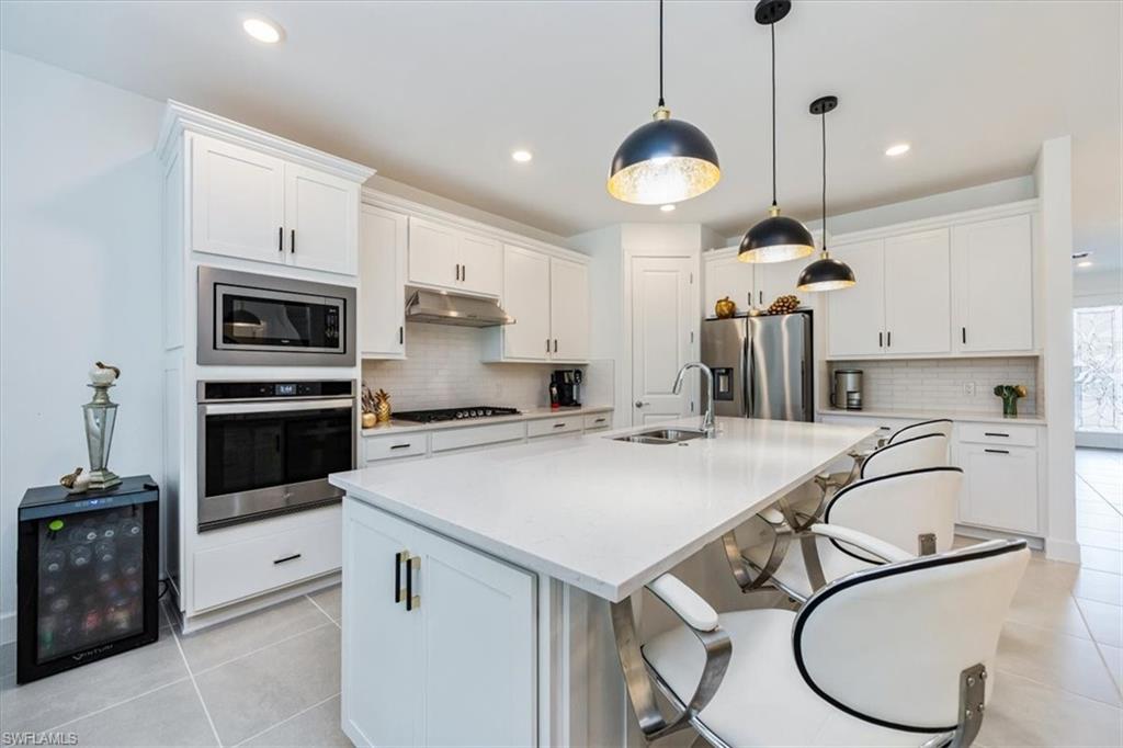 10499 Ventana Lane Naples, FL 34120 - Photo 5 of 22 Spacious great room with open concept to kitchen and access to amazing outdoor space