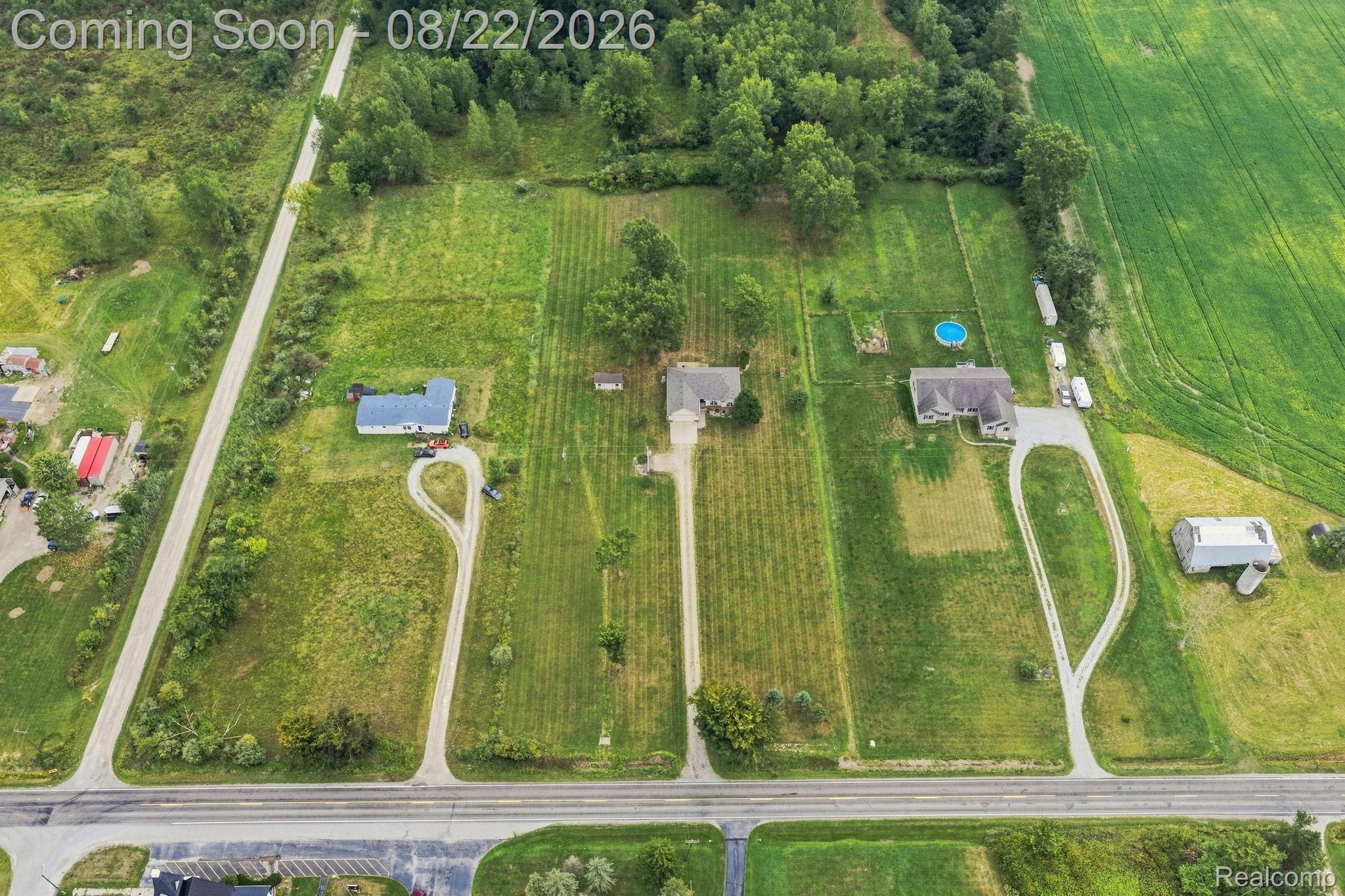 1301 Palms Road Columbus, MI 48063 - Photo 4 of 51 Expansive acreage featuring three distinct residences, a detached outbuilding, a circular driveway, and a partially wooded perimeter