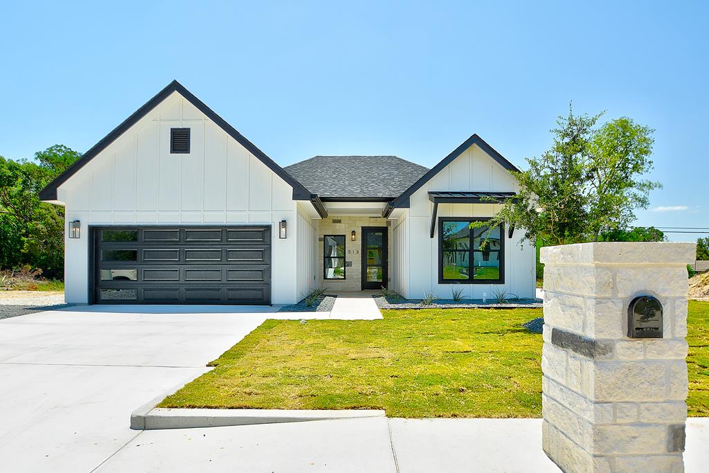 a white house with a large pool in front of it