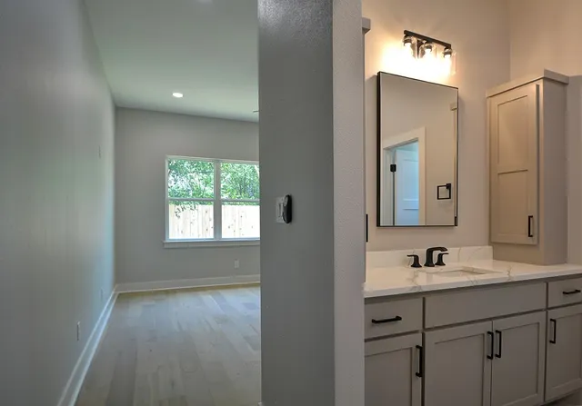 a bathroom with a sink double vanity and a mirror
