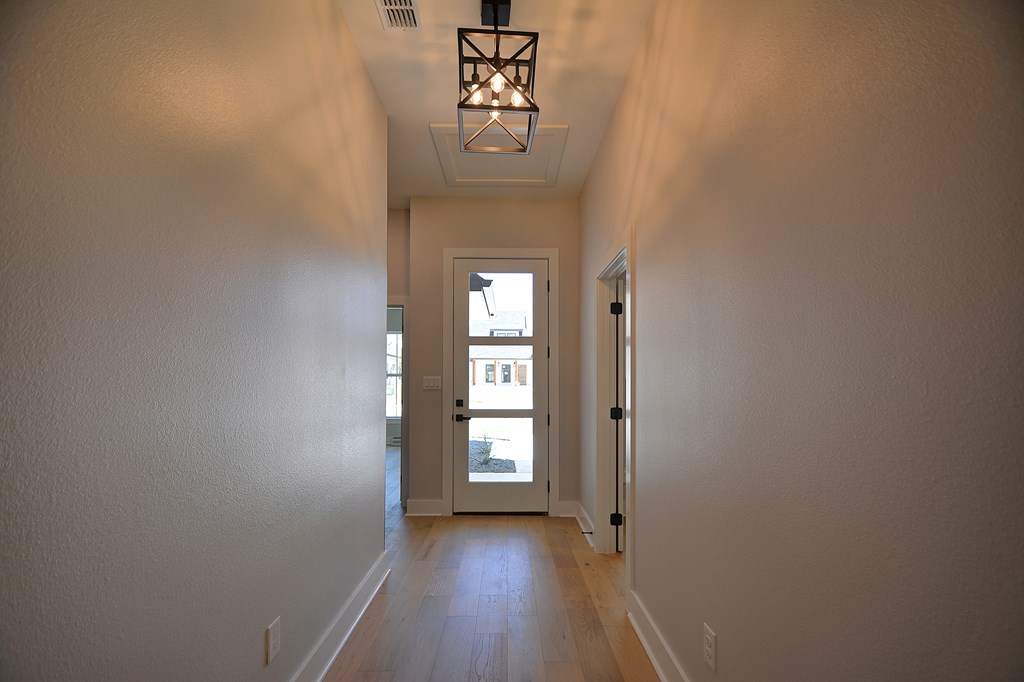513 Conner Court Kerrville, TX 78028 - Photo 31 of 54 a view of a hallway with wooden floor and a window