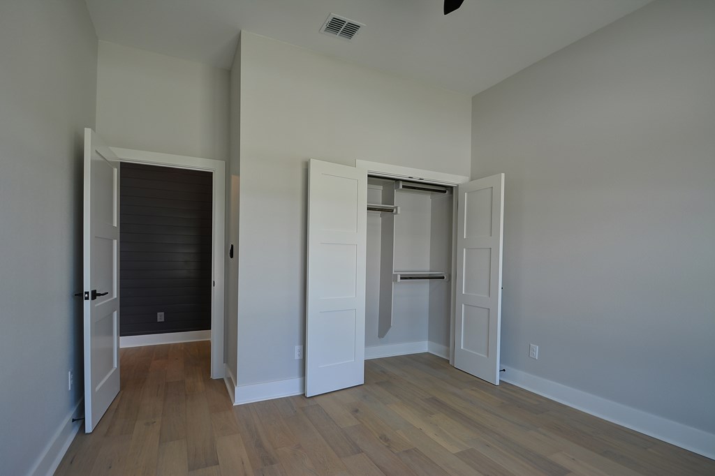 513 Conner Court Kerrville, TX 78028 - Photo 35 of 54 a view of an empty room with closet and wooden floor