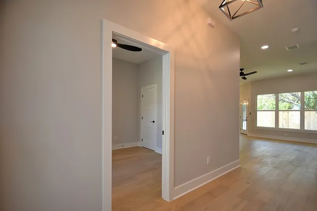 an empty room with closet and a bathroom