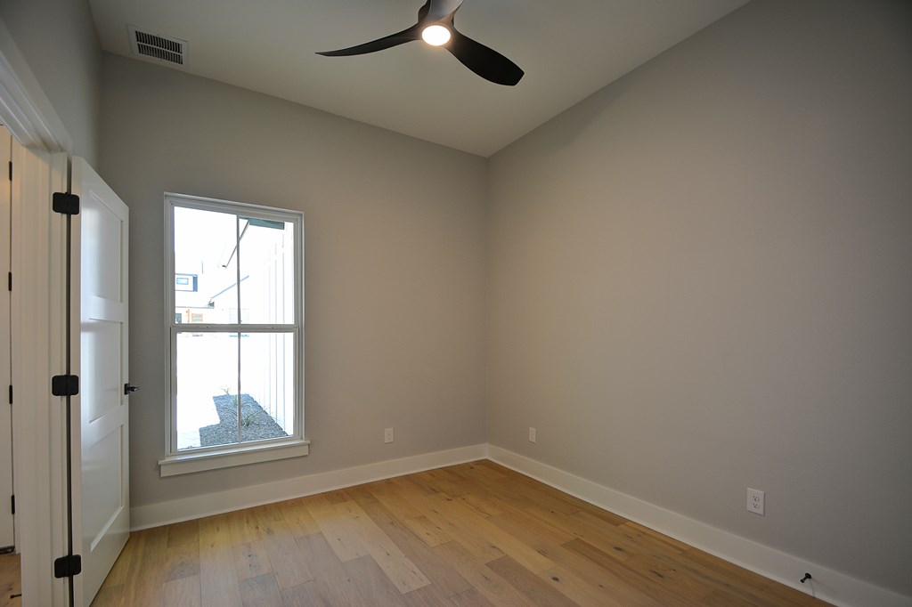513 Conner Court Kerrville, TX 78028 - Photo 43 of 54 an empty room with wooden floor and windows