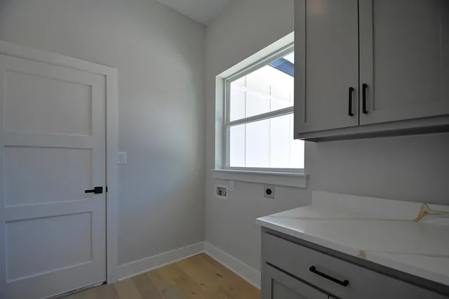 a view of an empty room with a fireplace and a window