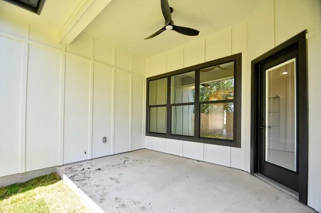 a view of a house with backyard and a tree