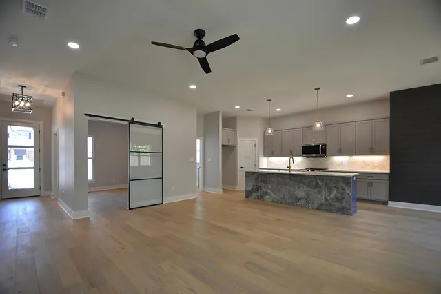 a view of a kitchen with a sink and a refrigerator