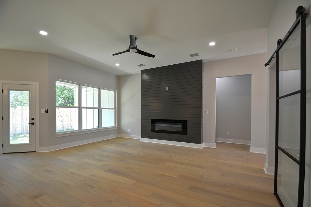 513 Conner Court Kerrville, TX 78028 - Photo 7 of 54 a view of an empty room with a fireplace and a window
