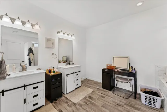 a spacious bathroom with a double vanity sink and a mirror
