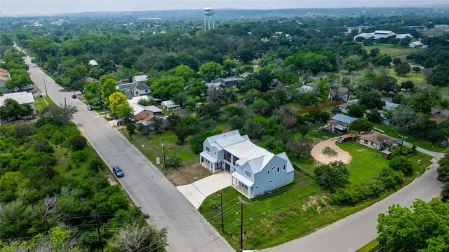 an aerial view of a house with a yard