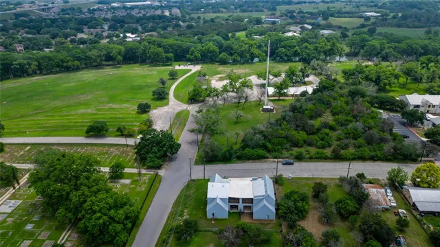 an aerial view of a house with a garden and lake view