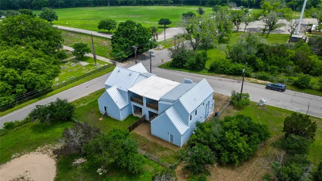 an aerial view of a house with a yard