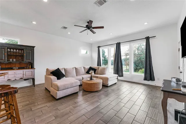 a living room with furniture and large windows