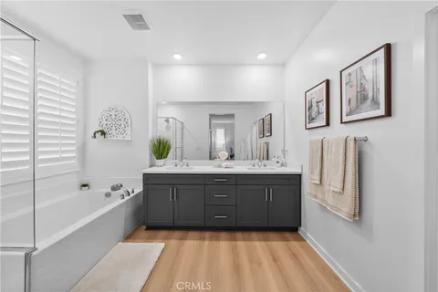 a bathroom with a tub sink and mirror