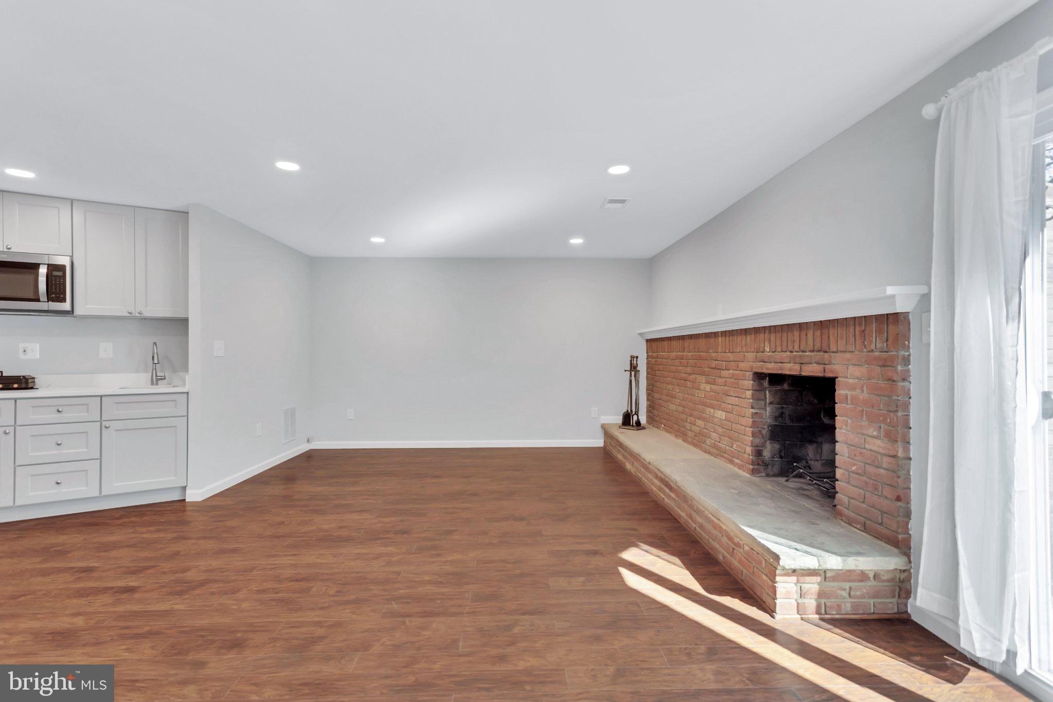 9009 Sweet Birch Court Springfield, VA 22152 - Photo 27 of 34 Spacious living area with cozy fireplace.