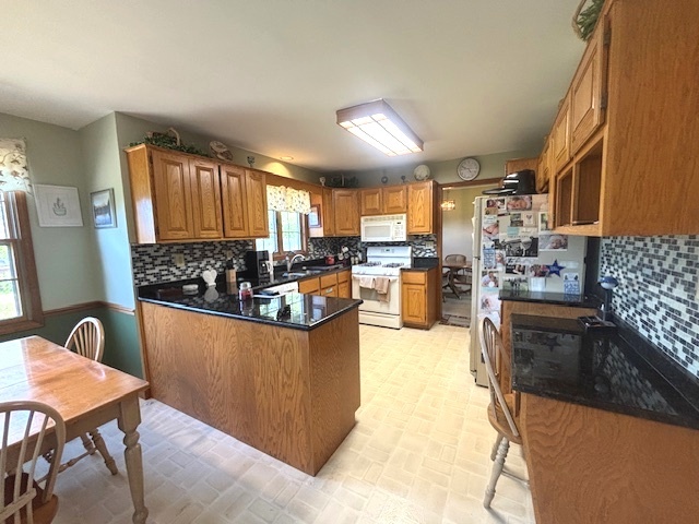 2228 Hess Drive Crest Hill, IL 60403 - Photo 5 of 19 a kitchen with granite countertop a stove a sink dishwasher a refrigerator and cabinets with wooden floor
