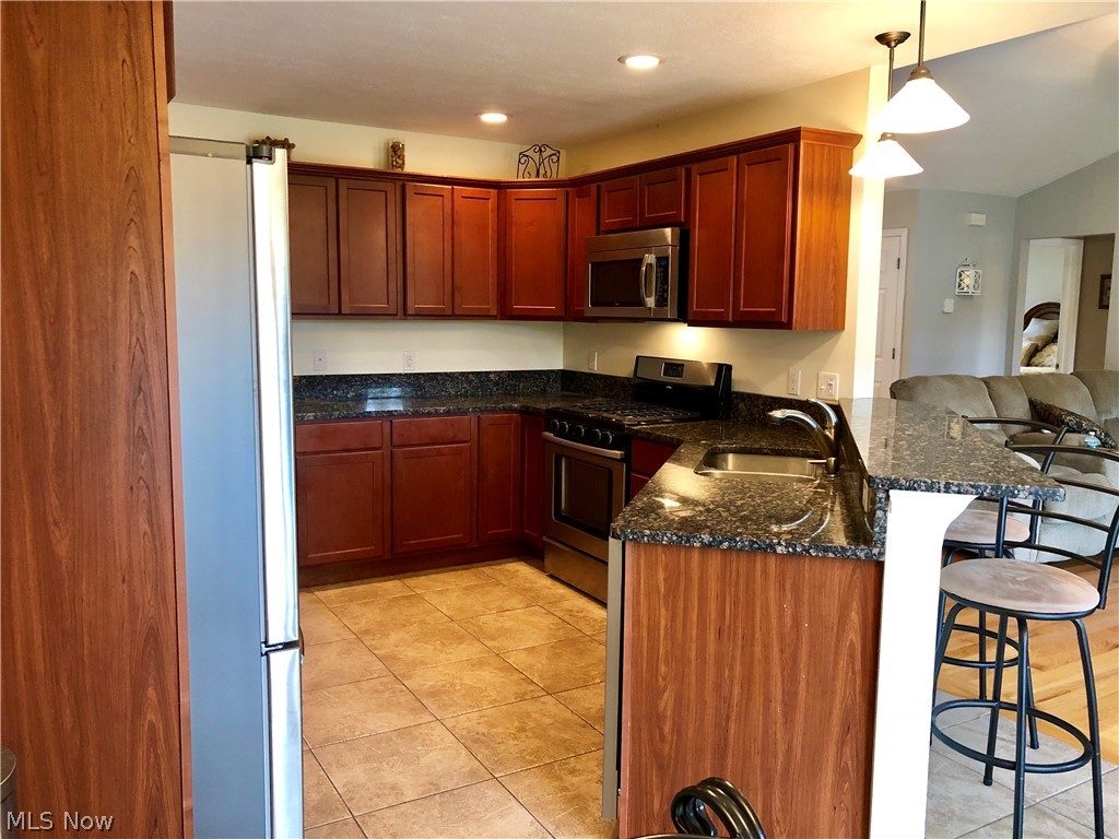 3312 Ridgely Park Youngstown, OH 44514 - Photo 11 of 31 Your kitchen boasts Black Granite counter tops, a breakfast bar, lots of Cherry Finished cabinets, New Stainless Steel dishwasher & New Stainless Steel refrigerator.