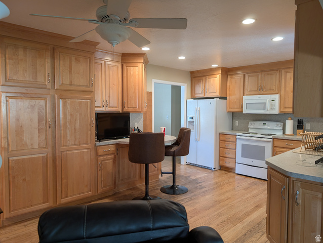 1411 Millbrook Way Bountiful, UT 84010 - Photo 11 of 36 Kitchen featuring wood-finish flooring, recessed lighting, a ceiling fan, light wood cabinetry providing ample storage, and white appliances