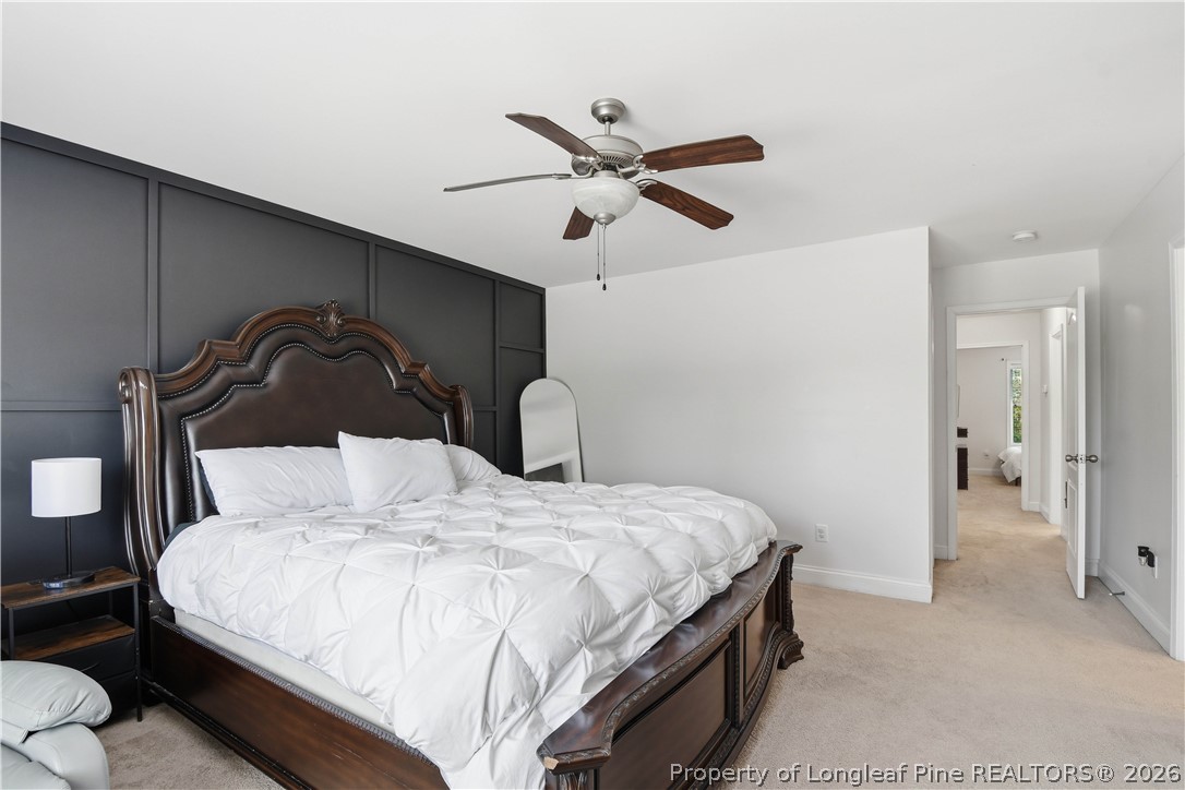 140 Birch Avenue Spring Lake, NC 28390 - Photo 45 of 49 a bedroom with a bed and a ceiling fan