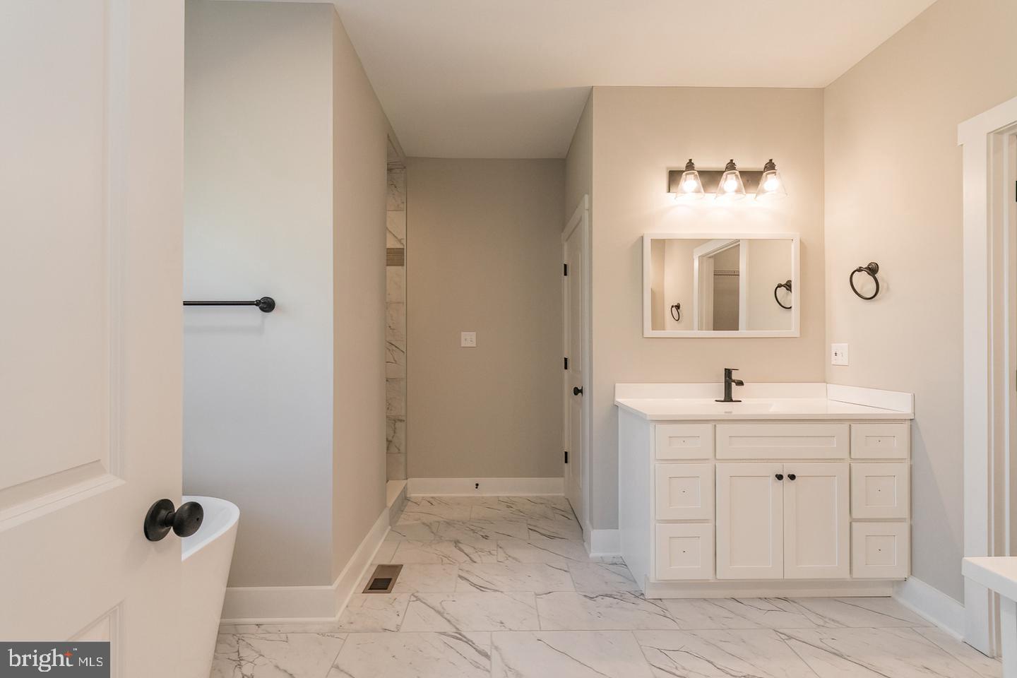 21 Steamboat Run Road Shepherdstown, WV 25443 - Photo 13 of 35 a spacious bathroom with a granite countertop sink a mirror and a